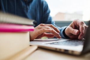 Modern education - get a degree online. Learning your profession on the internet. Man is studying using laptop