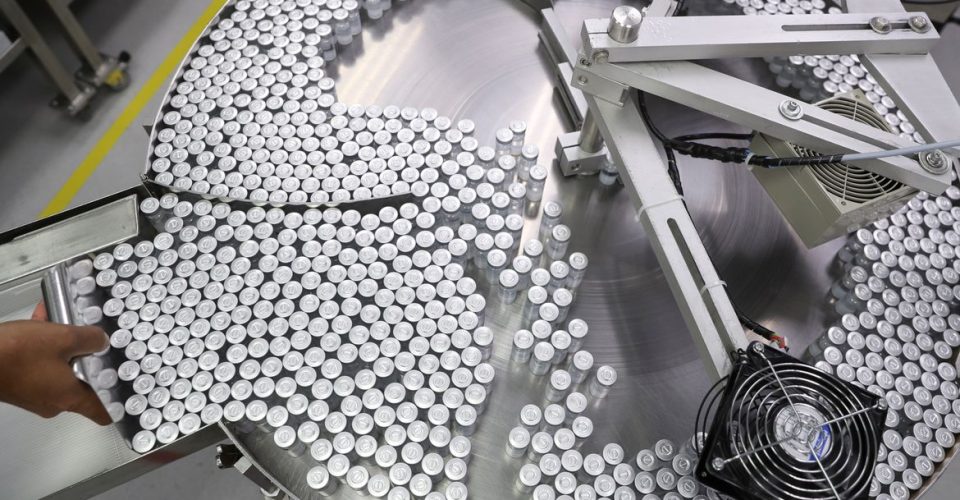 An employee puts on an equipment vials containing CoronaVac, Sinovac's vaccine against the coronavirus disease (COVID-19), at Butantan biomedical production center in Sao Paulo, Brazil January 22, 2021. REUTERS/Amanda Perobelli